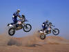 this is an picture of a pair of BMW GS motorcycles jumping